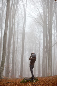 Man standing in forest during winter