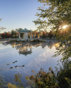 Scenic view of lake by buildings against sky