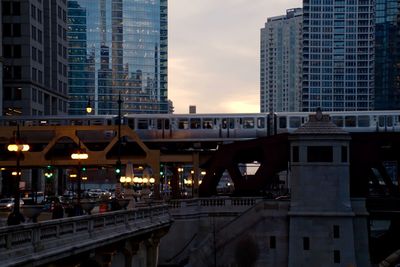 Bridge in city against sky