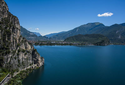 Scenic view of sea and mountains against blue sky