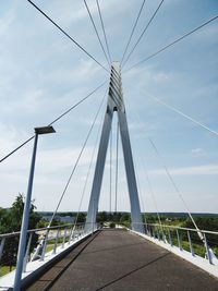 Low angle view of suspension bridge against sky