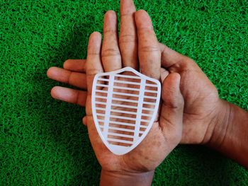 Close-up of human hand holding grass