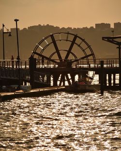 Bridge over river at sunset