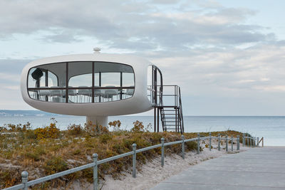 Lifeguard hut on beach against sky