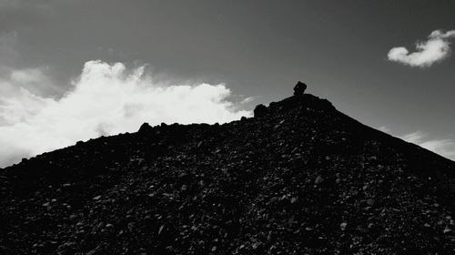 Low angle view of mountain against cloudy sky