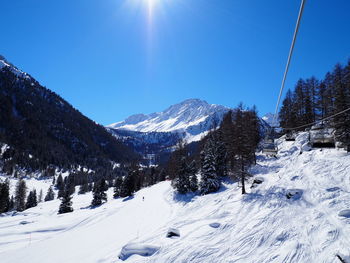 Scenic view of snow covered mountains against clear sky