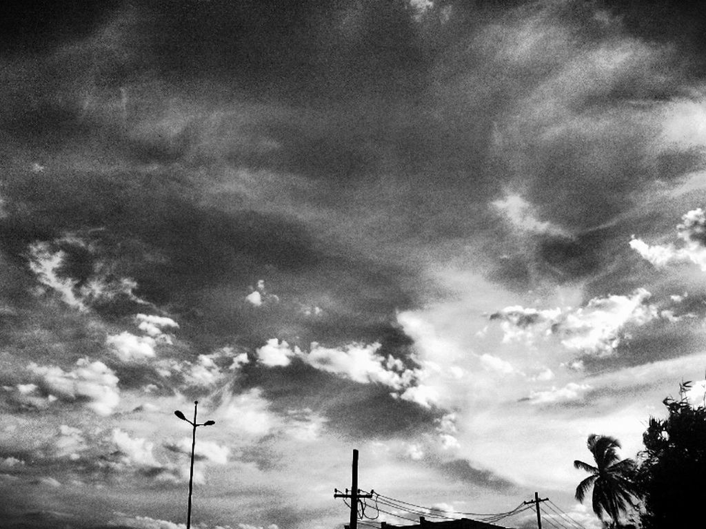 low angle view, sky, cloud - sky, cloudy, cloud, nature, tranquility, silhouette, overcast, street light, beauty in nature, weather, outdoors, no people, day, fuel and power generation, tree, technology, power line, electricity pylon