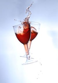 Close-up of drink on glass against white background