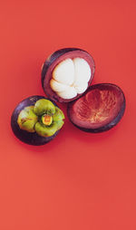 High angle view of fruits against red background