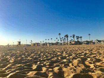 Scenic view of beach against clear blue sky