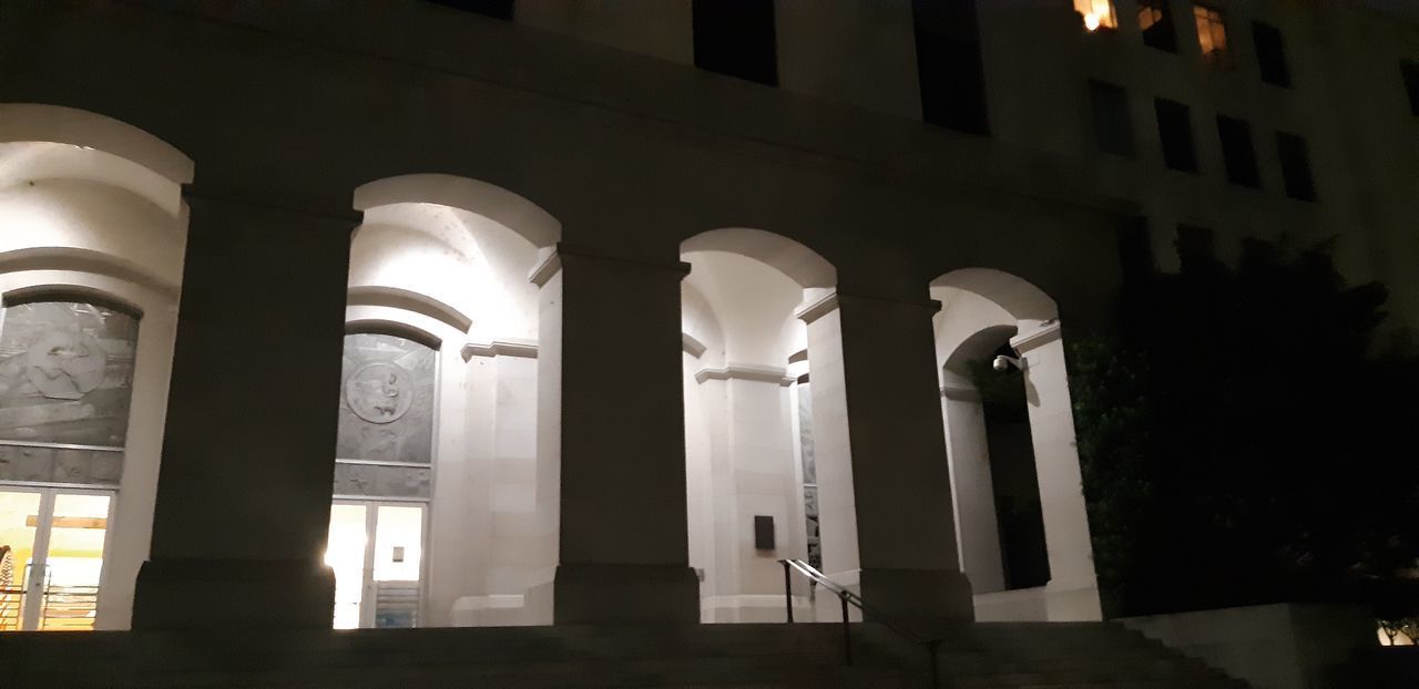 LOW ANGLE VIEW OF ILLUMINATED BUILDING IN CITY