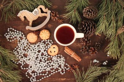 High angle view of coffee with cookies and christmas decorations on table