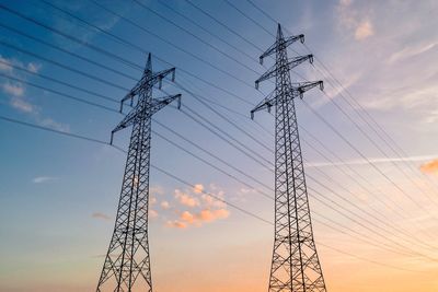 Low angle view of electricity pylon against sky