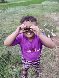Portrait of boy wearing sunglasses on field