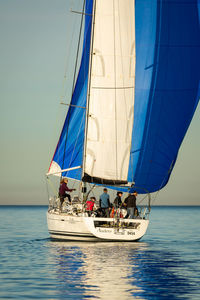 Sailboat sailing in sea against sky