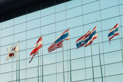 Low angle view of flags against sky