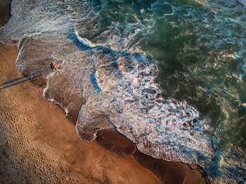 High angle view of rocks on sea shore