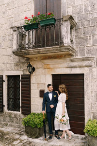 Woman standing by building