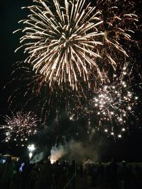 Low angle view of firework display at night