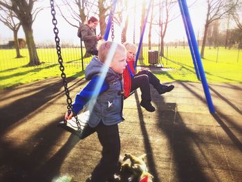 Children playing on swings in park