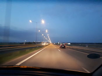 Cars on highway seen through car windshield