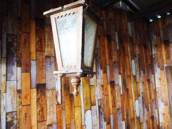 Low angle view of electric lamp hanging on ceiling