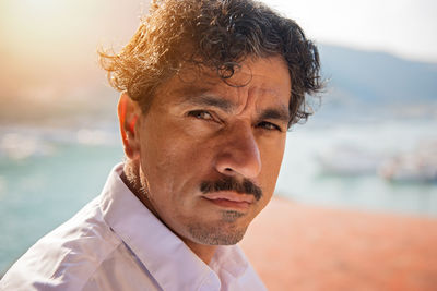 Close-up portrait of mature man at beach