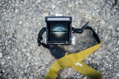 Close-up of vintage camera on rock