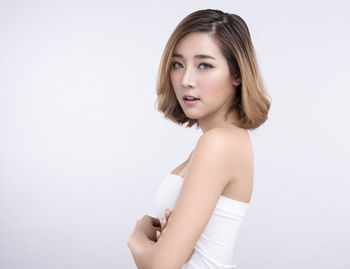 Portrait of a beautiful young woman over white background