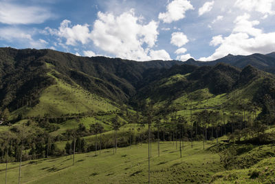 Scenic view of mountains against cloudy sky
