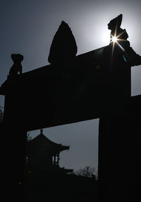 Low angle view of silhouette statue against sky during sunset