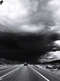 Car on highway against storm clouds