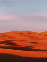 Scenic view of desert against sky during sunset