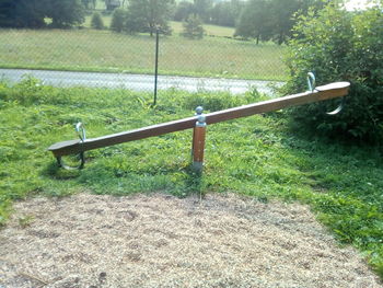 Empty park bench on field