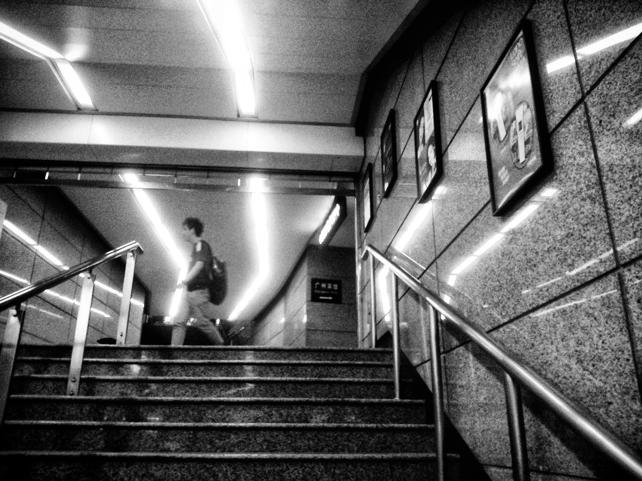 steps and staircases, steps, staircase, indoors, railing, escalator, illuminated, built structure, architecture, men, subway, moving up, the way forward, wall - building feature, stairs, moving down, lifestyles, convenience, high angle view