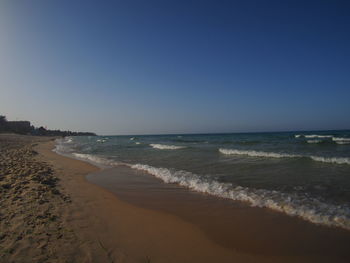 Scenic view of beach against clear sky