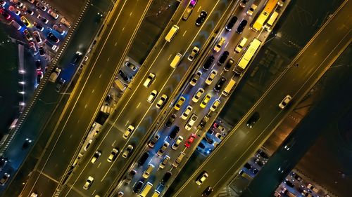 Low angle view of illuminated road in city at night