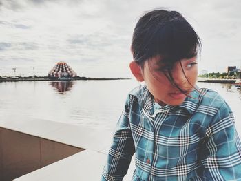 Portrait of girl looking away against sky