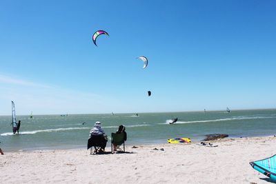 People on beach against sky