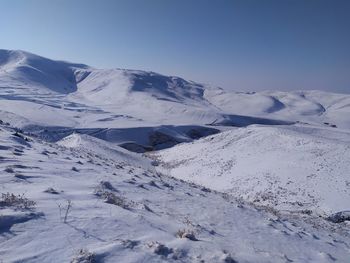 Scenic view of snow covered mountains against sky