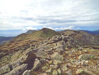 Scenic view of mountains against cloudy sky