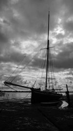 Sailboats moored in sea against sky