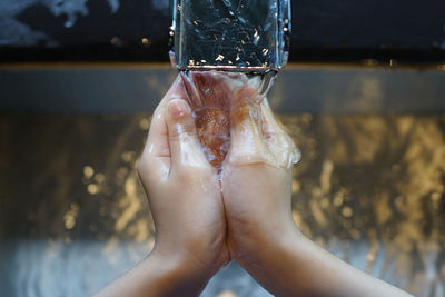 Close-up of human hand with water