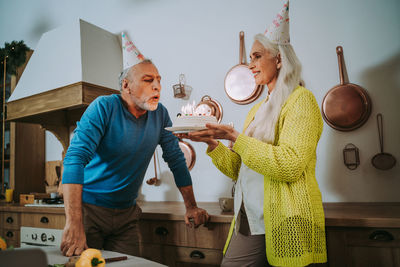 Man holding woman standing with vegetables