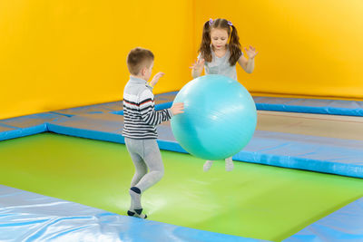 Full length of a boy playing with balloons