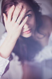 Portrait of a beautiful young woman covering face