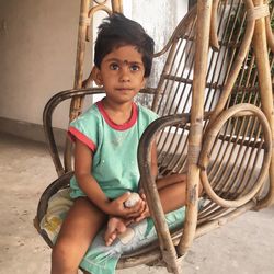 Portrait of cute girl sitting outdoors