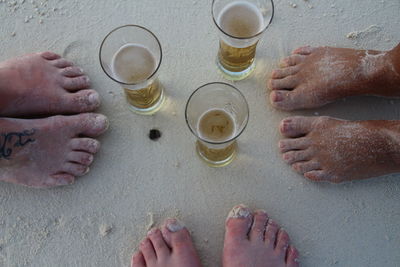 Low section of people on table at beach