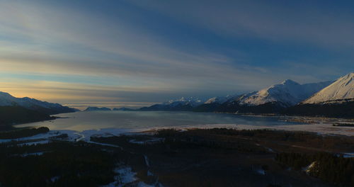 Scenic view of snowcapped mountains against sky during sunset