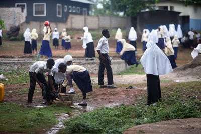 Rear view of people walking in temple